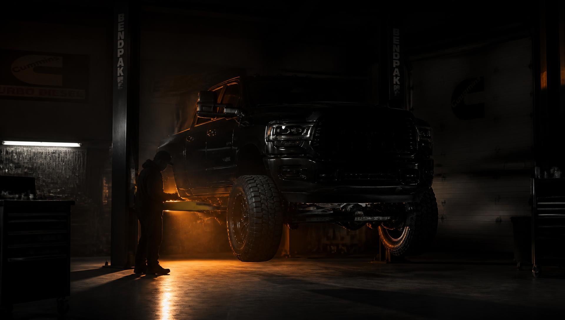 Diesel pickup truck on a lift being serviced at Posey Customs in Martindale, Texas